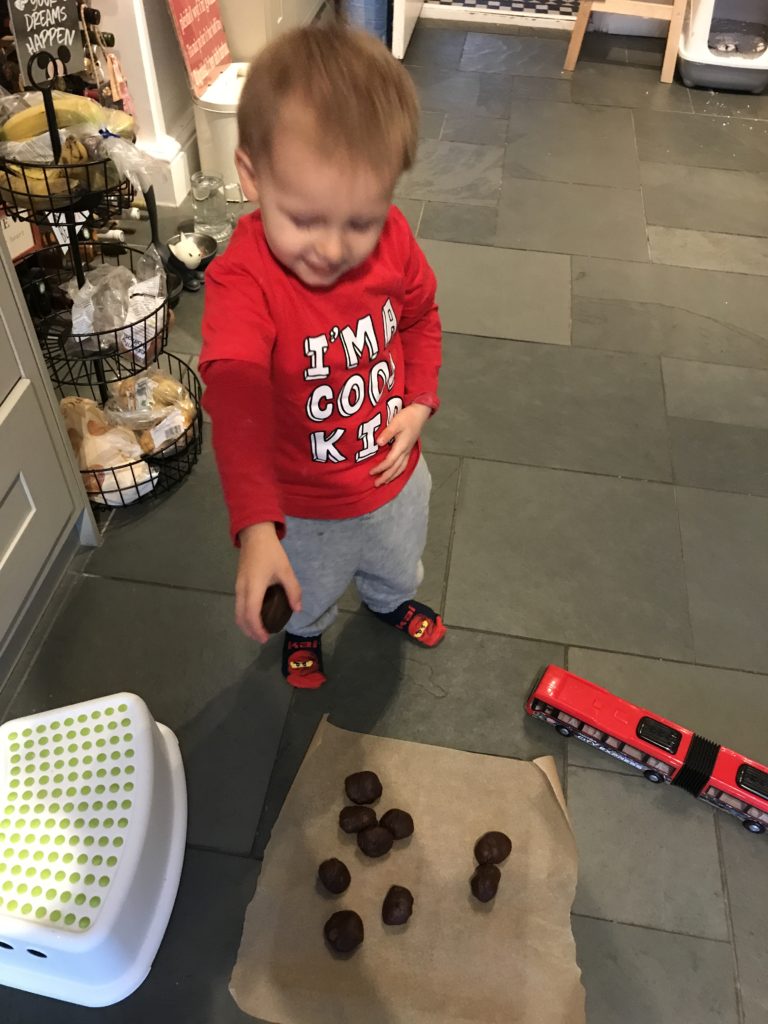 Ioan dropping cookies on a tray