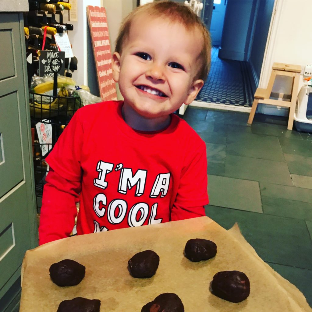 Ioan smiling with a tray of cookies