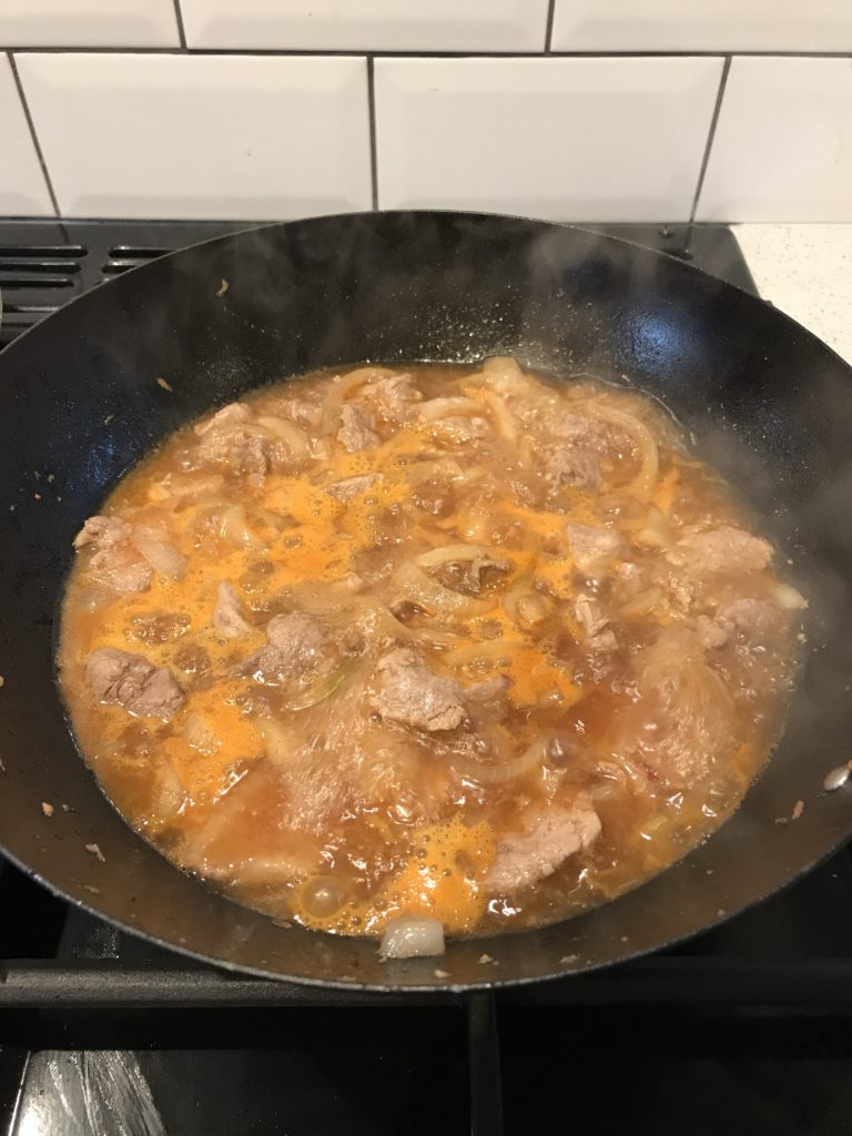 Vietnamese caramel pork bubbling on stove