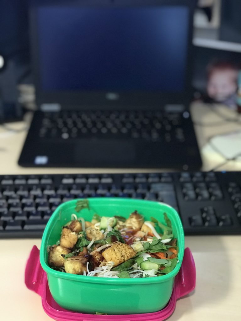 South East Asian inspired tofu noodle salad at desk